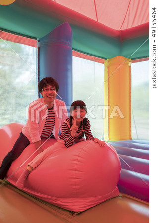 Parents playing with amusement park air playground equipment 49155464