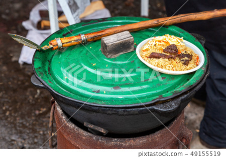 Cooking traditional Uzbek pilaf in a large Cooking traditional Uzbek pilaf in a large 49155519