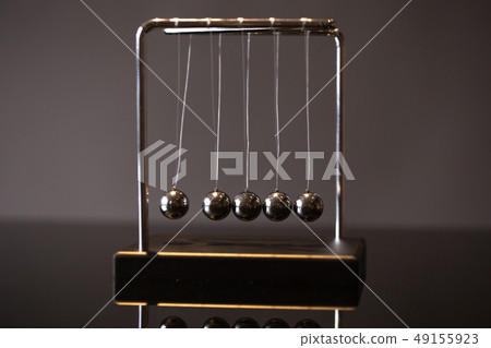Newton cradle representing momentum 49155923