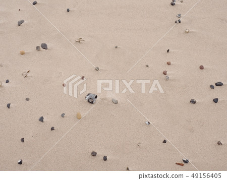 Sand of beach with soft waves and pebbles in sunny 49156405