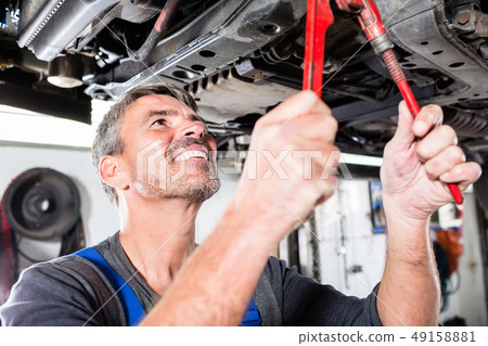 Smiling mature man repairing the car 49158881