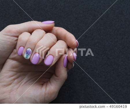 Fashionable lilac manicure design in the hand. 49160419