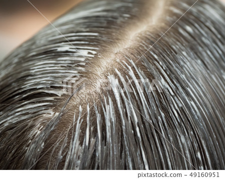 Tinted hair on the head. Hair parting on the head. Tinted hair on the head. Hair parting on the head. 49160951