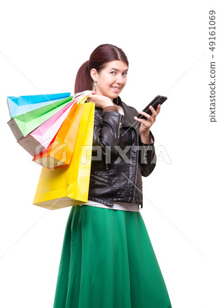 Happy young woman with shopping bags and phone 49161069