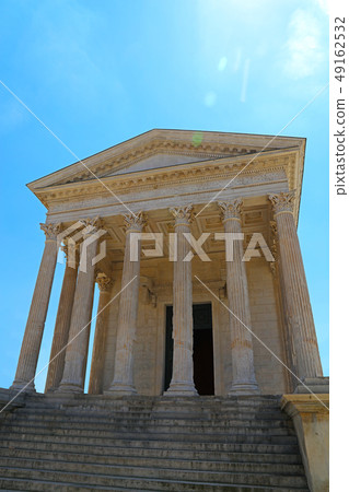 Facade of antique Roman temple over blue sky Facade of antique Roman temple over blue sky 49162532