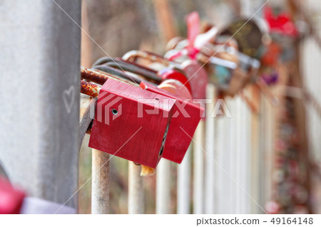 many old locks hang on iron fence many old locks hang on iron fence 49164148