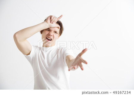 Losers go home. Portrait of happy guy showing loser sign over forehead 49167234