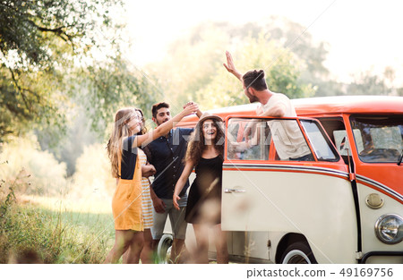 A group of young friends on a roadtrip through countryside. A group of young friends on a roadtrip through countryside. 49169756