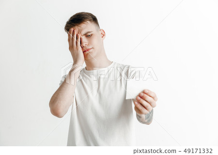Young boy with a surprised unhappy failure expression bet slip on studio background. 49171332