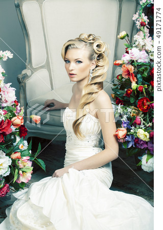 beauty emotional blond bride in luxury interior dreaming, crazy complicate hairstyle, many flowers beauty emotional blond bride in luxury interior dreaming, crazy complicate hairstyle, many flowers 49171774