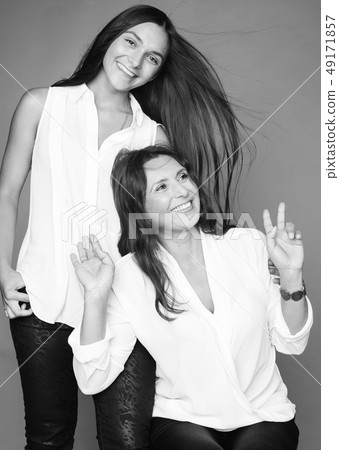 cute pretty teen daughter with mature mother hugging, fashion style brunette, lifestyle people cute pretty teen daughter with mature mother hugging, fashion style brunette, lifestyle people 49171857