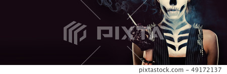 Woman with skeleton face art smoking  49172137