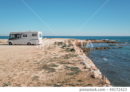 Lonely camper at the station on the coast  49172423