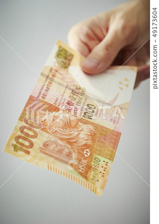 Male hand holding Hong Kong dollar banknote Male hand holding Hong Kong dollar banknote 49173604