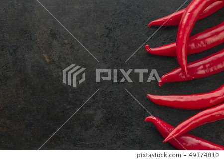 red chilli peppers on rusty metal background 49174010