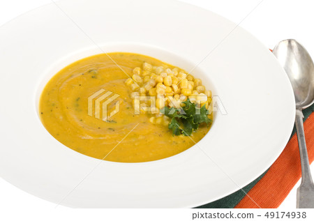 White plate with corn mash soup 49174938