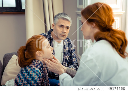 Sad worried father looking at the doctor Sad worried father looking at the doctor 49175368