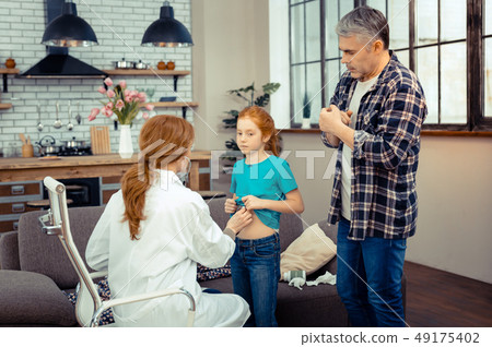 Serious mature man worrying about his daughters health 49175402