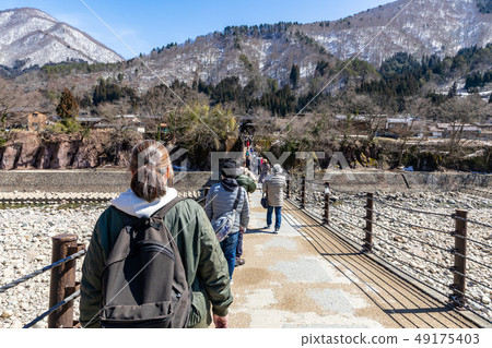 Shirakawago crossing the Aikawa bridge Shirakawago crossing the Aikawa bridge 49175403