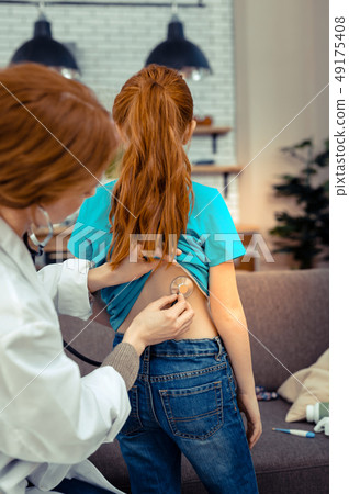 Nice pleasant girl having her health checked Nice pleasant girl having her health checked 49175408