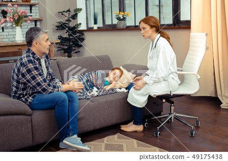 Sad worried man speaking to the doctor Sad worried man speaking to the doctor 49175438