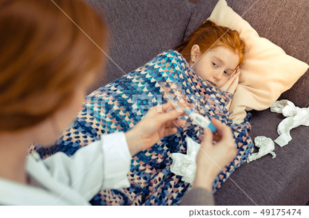 Nice cheerless girl looking at her doctor 49175474