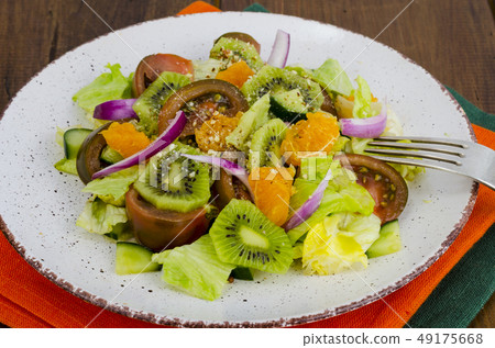Fruit and vegetable salad with tangerines. Fruit and vegetable salad with tangerines. 49175668