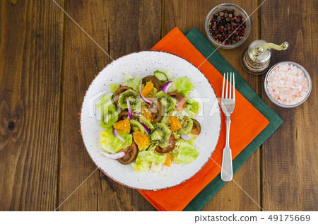 Fruit and vegetable salad with tangerines. Fruit and vegetable salad with tangerines. 49175669