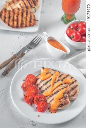 Grilled chicken breast with sauce and cherry Grilled chicken breast with sauce and cherry 49175670