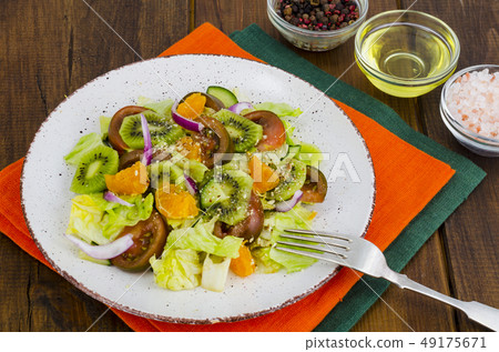 Fruit and vegetable salad with tangerines. Fruit and vegetable salad with tangerines. 49175671