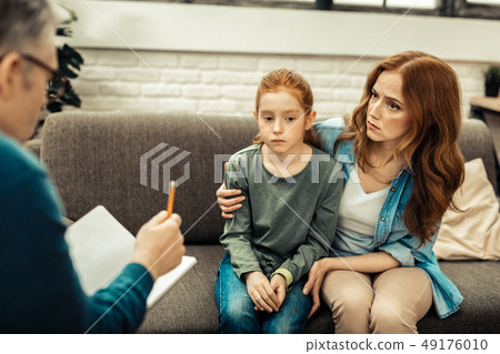 Sad nice woman looking at the doctor 49176010