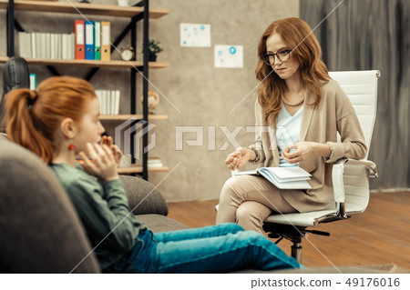 Nice professional female psychologist doing her job Nice professional female psychologist doing her job 49176016