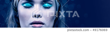 Woman with blue make-up isolated on blue 49176069