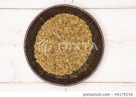 Roman caraway cumin on grey wood 49176556