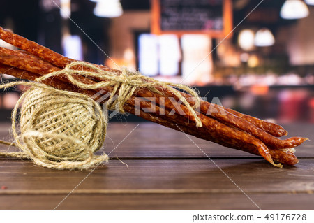 Spicy tyrolini salami stick in a restaurant 49176728