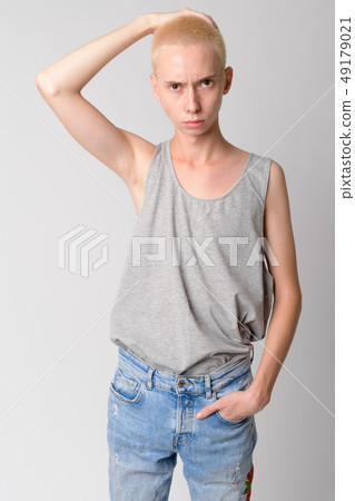 Portrait of young handsome androgynous man touching head 49179021