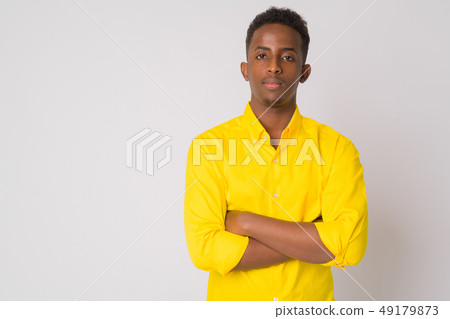 Young African businessman with yellow shirt crossing arms Young African businessman with yellow shirt crossing arms 49179873