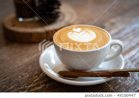 cappuccino with latte art on wooden background. cappuccino with latte art on wooden background. 49180447
