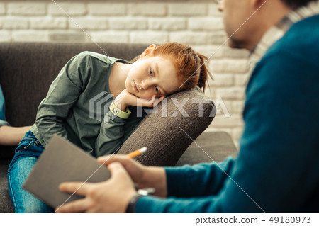 Sad unhappy girl leaning on the sofa 49180973