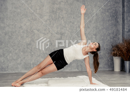 Young woman yoga on carpet at home living room. Young woman yoga on carpet at home living room. 49181484
