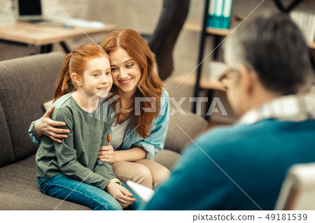 Delighted positive woman smiling to her daughter Delighted positive woman smiling to her daughter 49181539