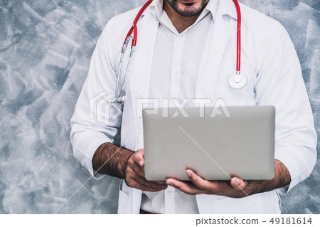 Doctor using laptop computer at the hospital. Doctor using laptop computer at the hospital. 49181614