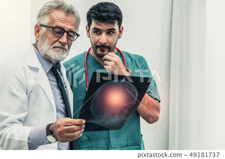 Doctor at hospital working on x ray film image. Doctor at hospital working on x ray film image. 49181737