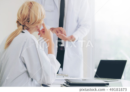 Female doctor at hospital talking to her partner. 49181873