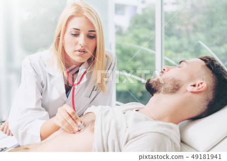 Woman Doctor and Male Patient in Hospital Office Woman Doctor and Male Patient in Hospital Office 49181941