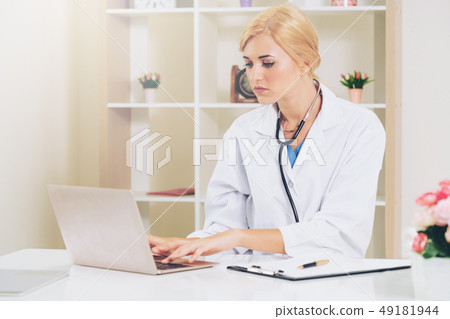 Young female doctor working in hospital office. Young female doctor working in hospital office. 49181944