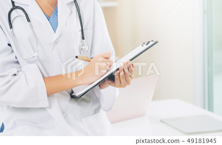 Young female doctor working in hospital office. Young female doctor working in hospital office. 49181945
