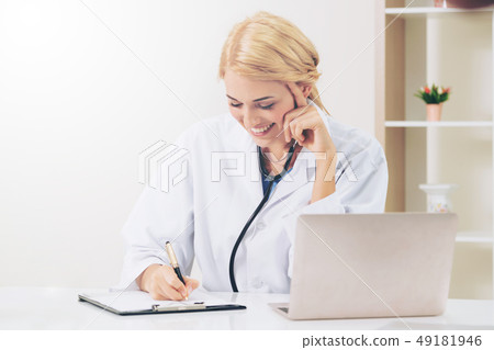 Young female doctor working in hospital office. Young female doctor working in hospital office. 49181946