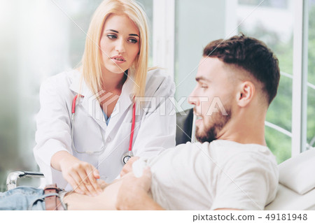 Woman Doctor and Male Patient in Hospital Office 49181948