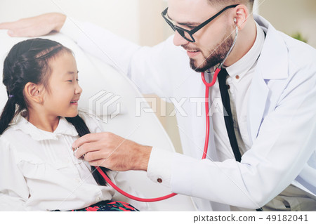 Doctor examining little happy kid in hospital. Doctor examining little happy kid in hospital. 49182041